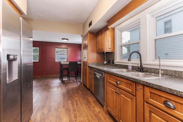 616 N Main St, Pontiac, IL 61764 - kitchen featuring stainless steel appliances, dark wood finished floors, dark countertops, and brown cabinetry