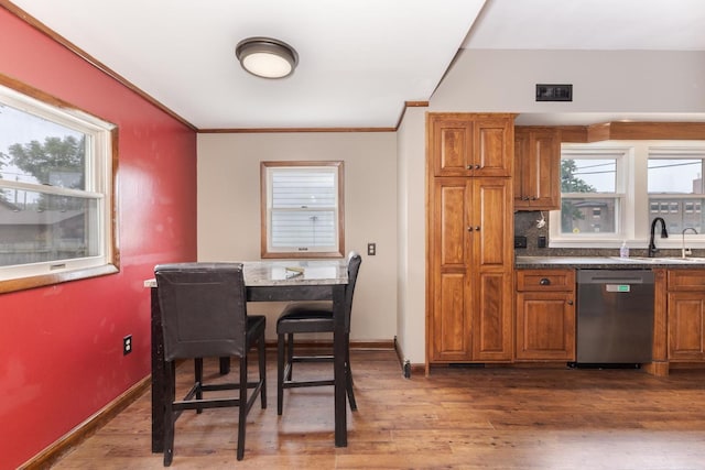 616 N Main St, Pontiac, IL 61764 - kitchen featuring dishwasher, brown cabinets, dark wood-type flooring, dark countertops, and crown molding