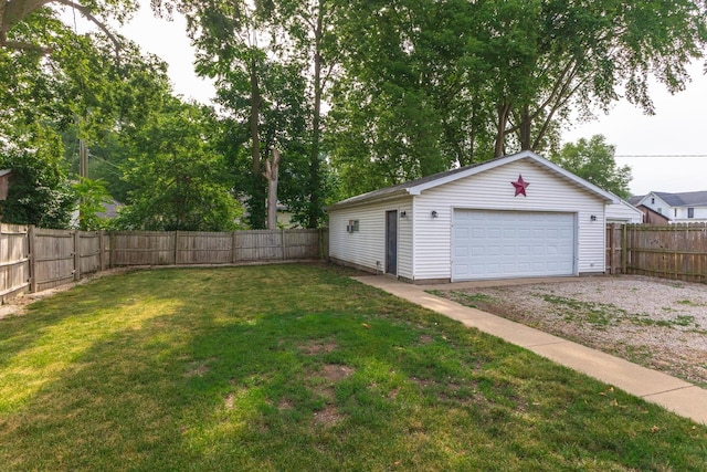 616 N Main St, Pontiac, IL 61764 - fenced backyard with a detached garage and an outbuilding