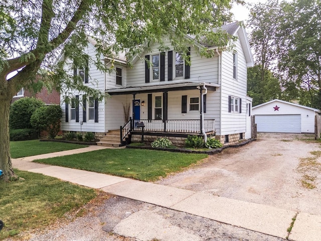616 N Main St, Pontiac, IL 61764 - view of front facade featuring a porch, an outbuilding, a front yard, and a detached garage