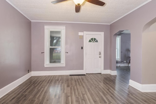 616 N Main St, Pontiac, IL 61764 - foyer with arched walkways, healthy amount of natural light, ceiling fan, wood finished floors, and crown molding