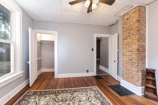 616 N Main St, Pontiac, IL 61764 - unfurnished bedroom with wood finished floors, a drop ceiling, ceiling fan, and a spacious closet