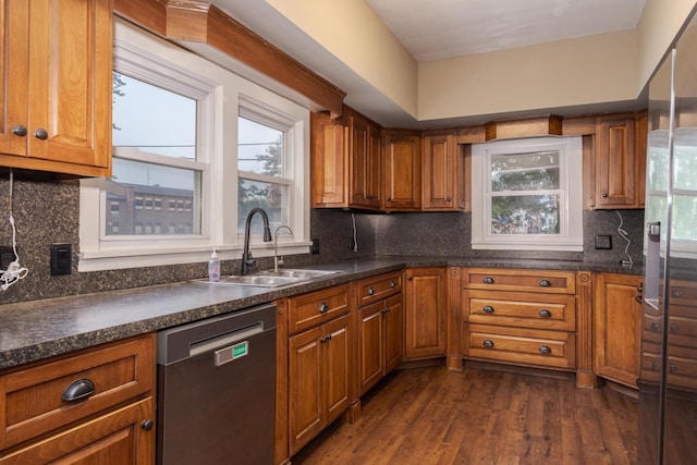 616 N Main St, Pontiac, IL 61764 - kitchen with stainless steel dishwasher, brown cabinetry, and dark countertops