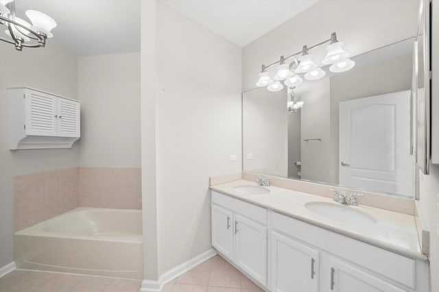 125 S Jefferson St Unit 1702, Chicago, IL 60661 - bathroom with tile patterned floors, double vanity, a garden tub, and a chandelier