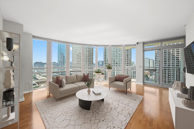 125 S Jefferson St Unit 1702, Chicago, IL 60661 - living area with a skyline view, wood finished floors, and floor to ceiling windows