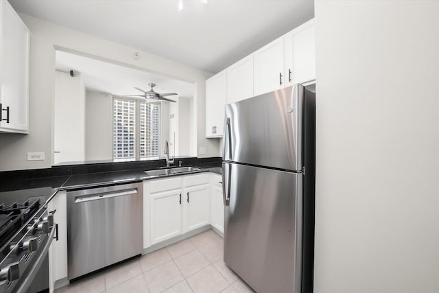125 S Jefferson St Unit 1702, Chicago, IL 60661 - kitchen featuring stainless steel appliances, light tile patterned floors, white cabinetry, and dark countertops