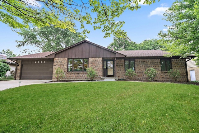 1622 Pickwick Ln, Dekalb, IL 60115 - view of front facade with an attached garage, brick siding, and a front yard