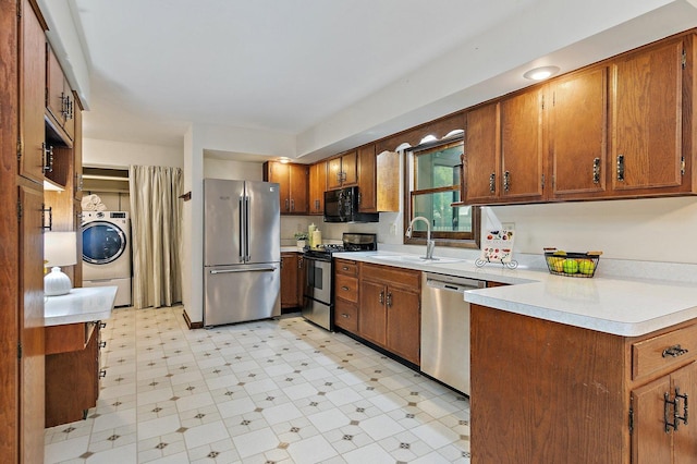 1622 Pickwick Ln, Dekalb, IL 60115 - kitchen featuring stainless steel appliances, washer / clothes dryer, light flooring, light countertops, and brown cabinets