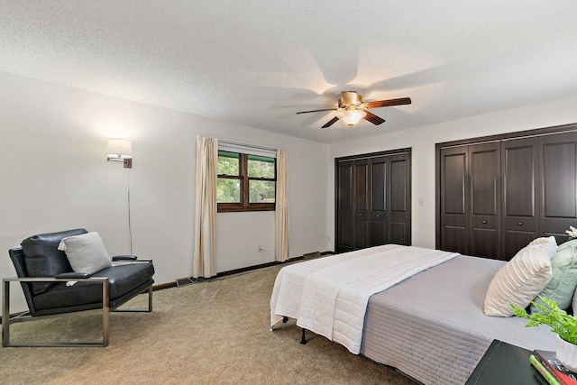 1622 Pickwick Ln, Dekalb, IL 60115 - bedroom with light carpet, two closets, a ceiling fan, and a textured ceiling
