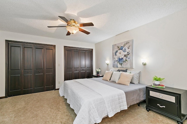 1622 Pickwick Ln, Dekalb, IL 60115 - bedroom with two closets, light carpet, a textured ceiling, and a ceiling fan