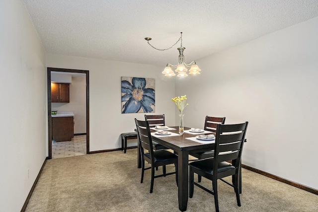 1622 Pickwick Ln, Dekalb, IL 60115 - dining room featuring a chandelier, light colored carpet, and a textured ceiling