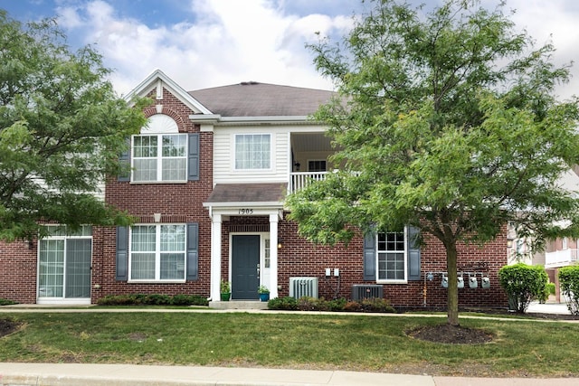 1905 Oxley Cir, Naperville, IL 60563 - traditional home with a balcony, a front lawn, brick siding, and a shingled roof