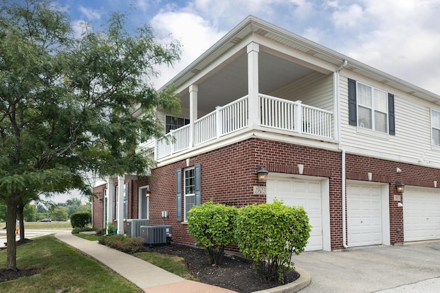 1905 Oxley Cir, Naperville, IL 60563 - view of side of property featuring a balcony, brick siding, and a garage