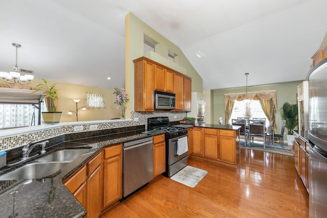 1905 Oxley Cir, Naperville, IL 60563 - kitchen featuring stainless steel appliances, a chandelier, a peninsula, tasteful backsplash, and hanging light fixtures