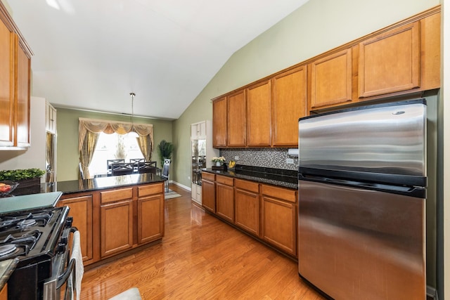 1905 Oxley Cir, Naperville, IL 60563 - kitchen with stainless steel appliances, brown cabinetry, lofted ceiling, light wood-style floors, and decorative backsplash