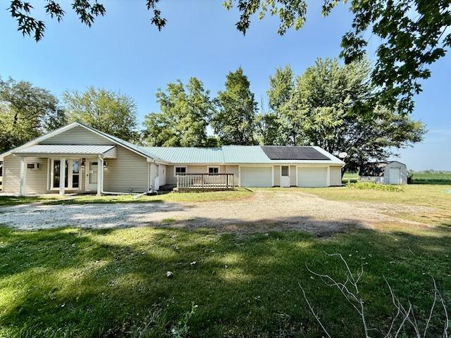 214 S Rising Rd, Champaign, IL 61822 - view of front of property featuring a front yard, a storage shed, dirt driveway, and a garage