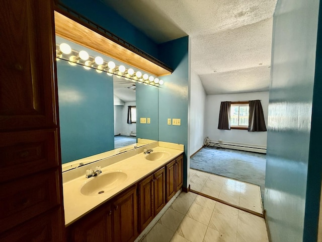 214 S Rising Rd, Champaign, IL 61822 - bathroom with baseboard heating, a textured ceiling, and double vanity