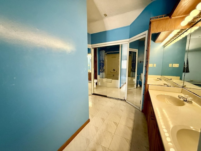 214 S Rising Rd, Champaign, IL 61822 - bathroom featuring double vanity, lofted ceiling, and tile patterned floors
