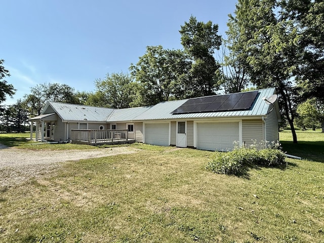 214 S Rising Rd, Champaign, IL 61822 - single story home featuring a front lawn, solar panels, a metal roof, driveway, and an attached garage