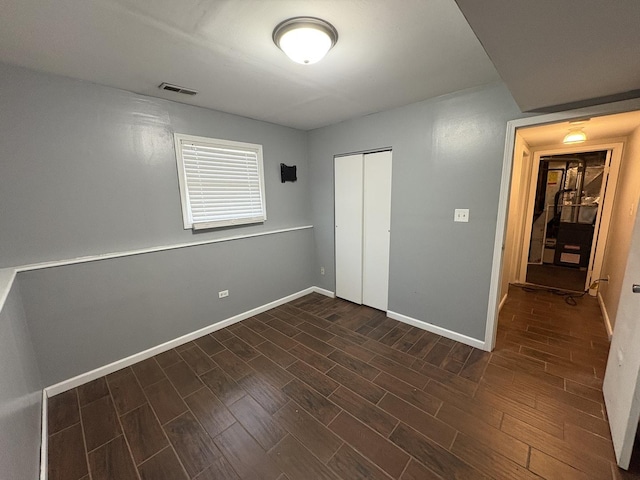 3219 Quincy Ct, Joliet, IL 60431 - unfurnished bedroom featuring dark wood-style floors and a closet