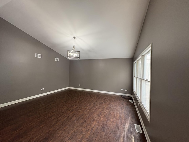 3219 Quincy Ct, Joliet, IL 60431 - empty room with lofted ceiling, dark wood finished floors, and a chandelier