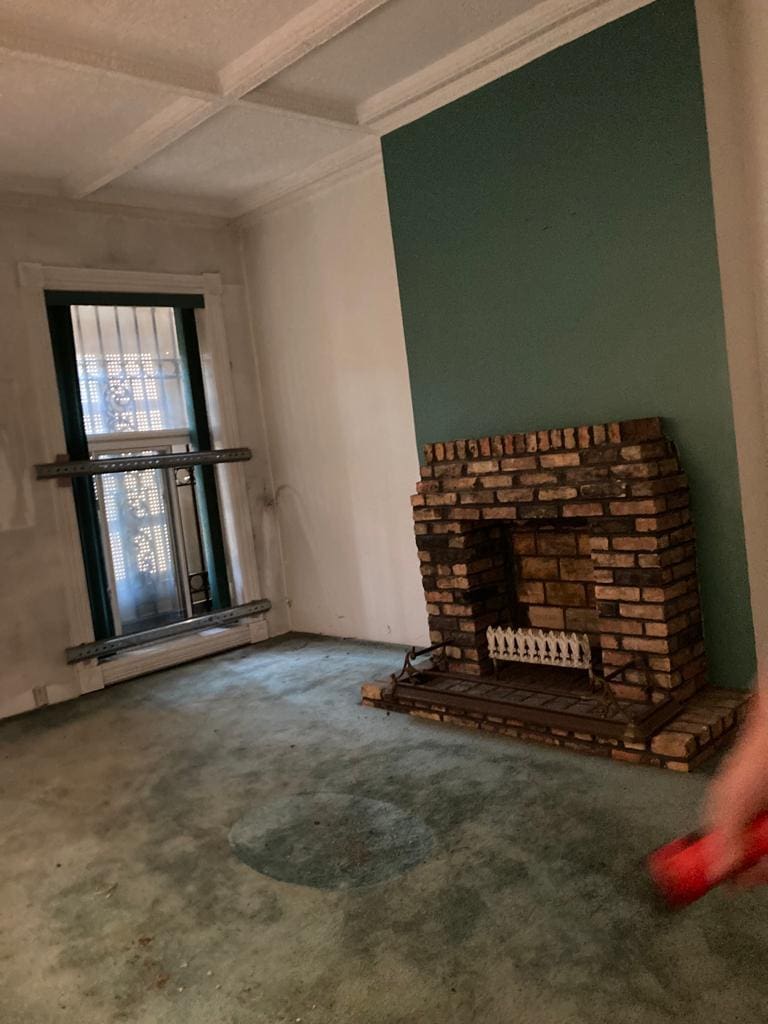 3143 S Giles Ave, Chicago, IL 60616 - unfurnished living room with beamed ceiling, coffered ceiling, and carpet flooring