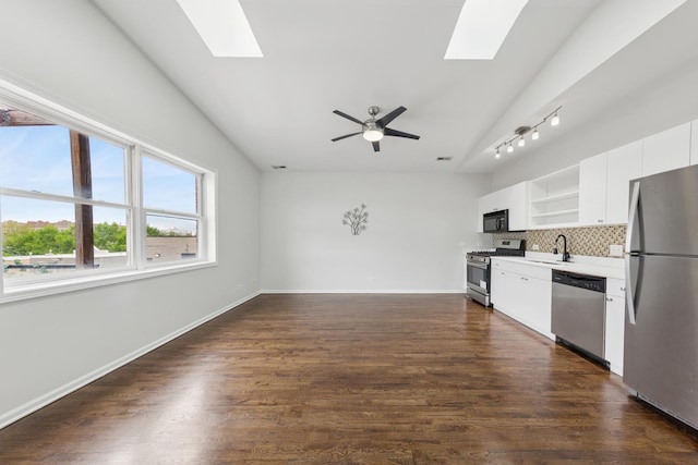 519 S Maplewood Ave Unit 4S, Chicago, IL 60612 - kitchen featuring appliances with stainless steel finishes, a skylight, open shelves, backsplash, and vaulted ceiling