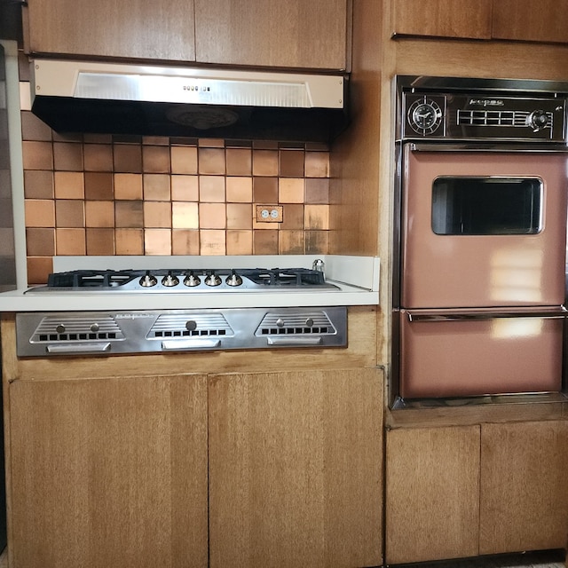 5549 W 83rd Pl, Burbank, IL 60459 - kitchen view of oven, ventilation hood, a warming drawer, decorative backsplash, and stainless steel gas cooktop