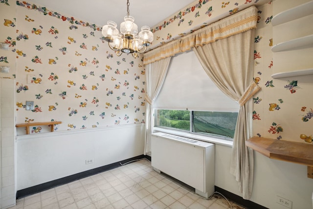 7033 N Kedzie Ave Unit 911, Chicago, IL 60645 - spare room featuring wallpapered walls, a chandelier, light floors, radiator heating unit, and a wainscoted wall