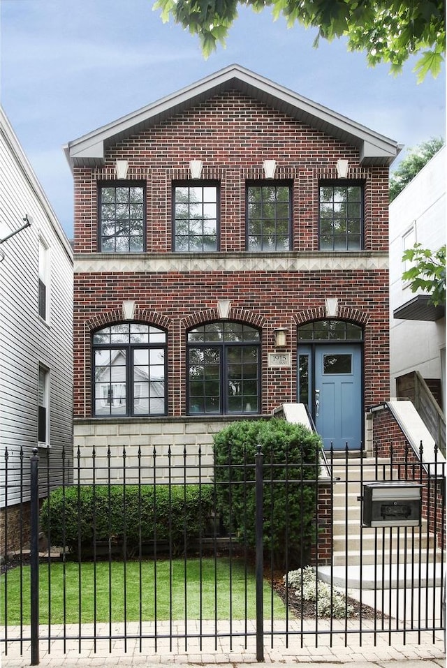 1915 N Albany Ave, Chicago, IL 60647 - view of front of house with brick siding and a fenced front yard