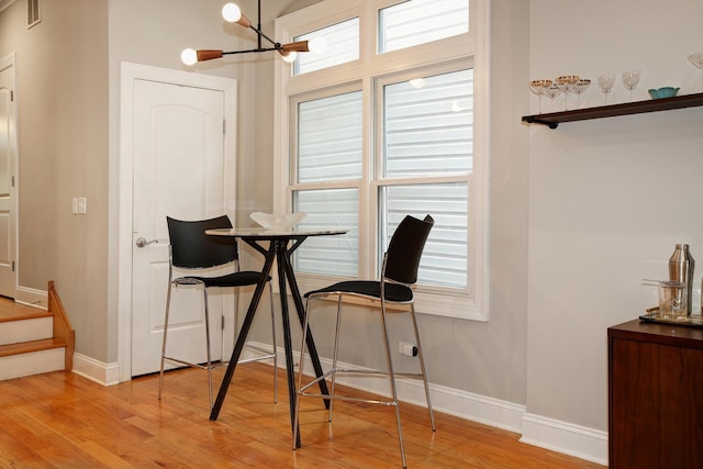 1915 N Albany Ave, Chicago, IL 60647 - dining area featuring light wood-style floors, a chandelier, and healthy amount of natural light