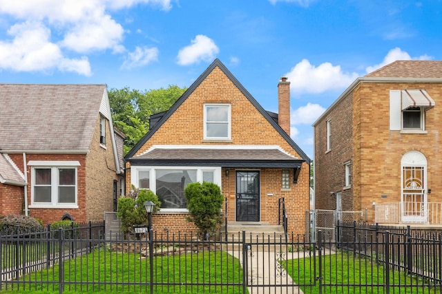 8623 S Prairie Ave, Chicago, IL 60619 - view of front of property with a chimney, a fenced front yard, brick siding, roof with shingles, and a gate