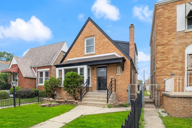 8623 S Prairie Ave, Chicago, IL 60619 - view of front of house with a gate, brick siding, a chimney, and roof with shingles