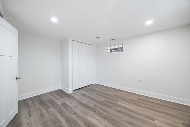 8623 S Prairie Ave, Chicago, IL 60619 - unfurnished bedroom with wood finished floors, recessed lighting, and a closet