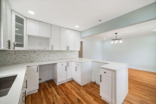8623 S Prairie Ave, Chicago, IL 60619 - kitchen with a peninsula, light wood finished floors, tasteful backsplash, white cabinets, and recessed lighting