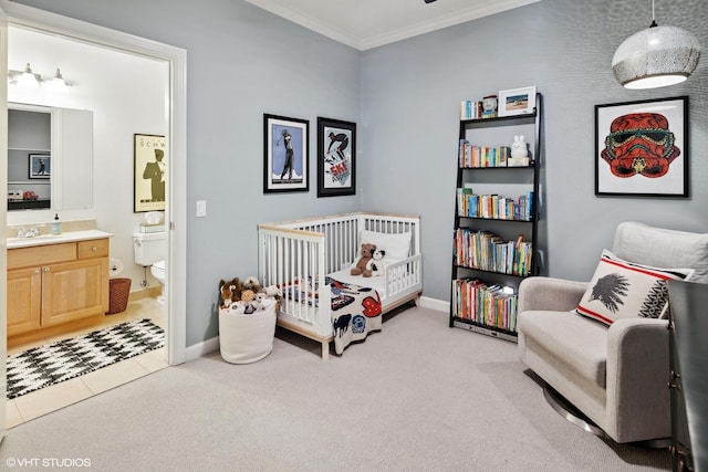 2107 W Belmont Ave Unit 2C, Chicago, IL 60618 - bedroom with crown molding, a crib, light carpet, ensuite bathroom, and light tile patterned floors