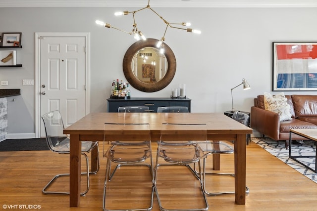 2107 W Belmont Ave Unit 2C, Chicago, IL 60618 - dining room featuring wood finished floors and crown molding