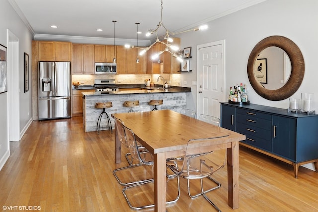 2107 W Belmont Ave Unit 2C, Chicago, IL 60618 - kitchen featuring stainless steel appliances, dark countertops, crown molding, a peninsula, and decorative backsplash
