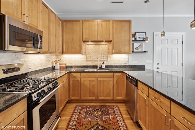 2107 W Belmont Ave Unit 2C, Chicago, IL 60618 - kitchen with appliances with stainless steel finishes, ornamental molding, light wood-style flooring, dark stone counters, and tasteful backsplash