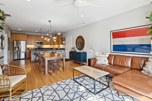 2107 W Belmont Ave Unit 2C, Chicago, IL 60618 - living room with crown molding, recessed lighting, wood finished floors, and ceiling fan