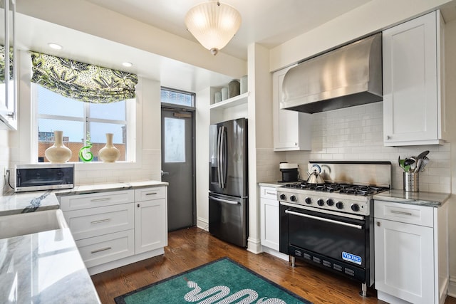 3750 N Lake Shore Dr Unit 16H, Chicago, IL 60613 - kitchen featuring fridge with ice dispenser, wall chimney exhaust hood, range with two ovens, tasteful backsplash, and light stone counters