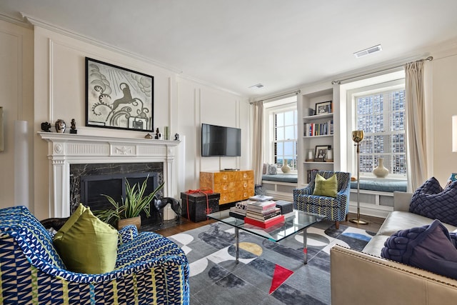 3750 N Lake Shore Dr Unit 16H, Chicago, IL 60613 - living area featuring built in shelves, wood finished floors, a high end fireplace, and crown molding