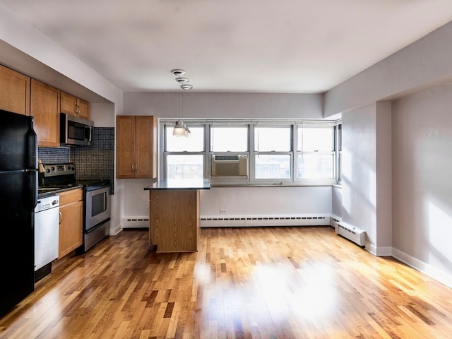 4960 N Marine Dr Unit 616, Chicago, IL 60640 - kitchen with appliances with stainless steel finishes, a baseboard heating unit, plenty of natural light, and a baseboard radiator