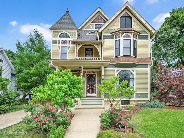 442 Du Page St, Elgin, IL 60120 - victorian-style house featuring a porch, a front yard, and a shingled roof