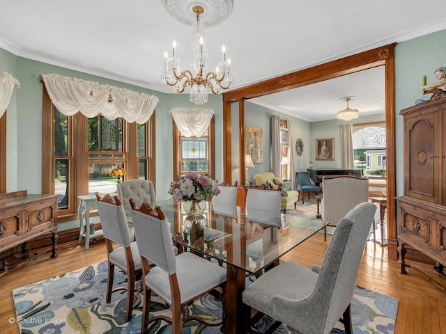 442 Du Page St, Elgin, IL 60120 - dining space featuring a chandelier, crown molding, and light wood-type flooring