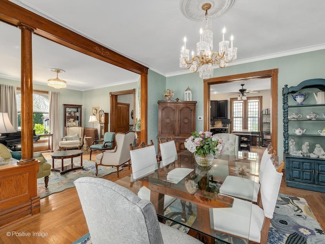442 Du Page St, Elgin, IL 60120 - dining space with a ceiling fan, decorative columns, light wood-style floors, a chandelier, and ornamental molding
