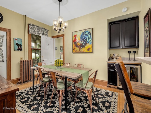 442 Du Page St, Elgin, IL 60120 - dining area with radiator, light wood-style flooring, and a chandelier