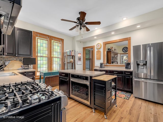 442 Du Page St, Elgin, IL 60120 - kitchen featuring stainless steel appliances, ceiling fan, light wood-type flooring, recessed lighting, and a kitchen island