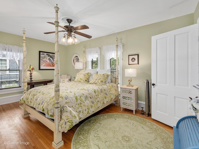 442 Du Page St, Elgin, IL 60120 - bedroom featuring wood finished floors, radiator heating unit, and a ceiling fan