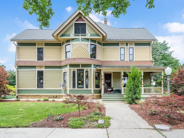 442 Du Page St, Elgin, IL 60120 - victorian home featuring a chimney, covered porch, a front lawn, and roof with shingles